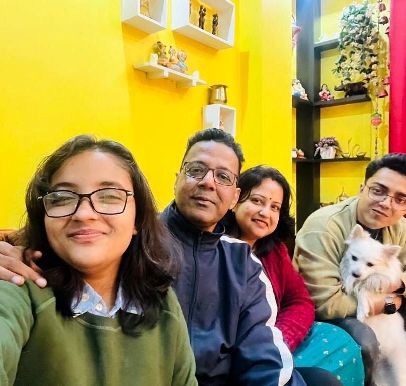 The VetMart family holding their beloved pet dog at home in Guwahati